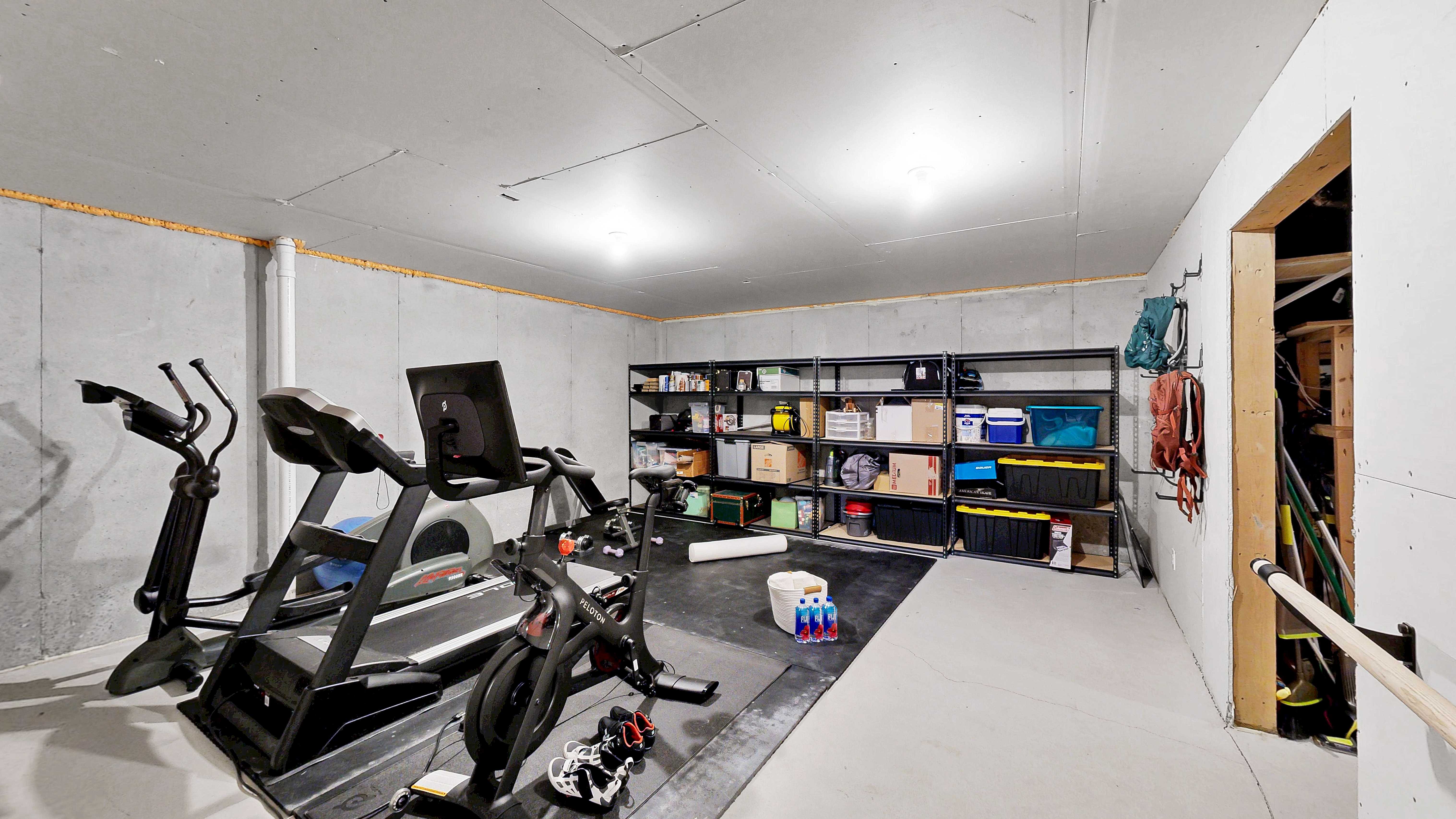 Lower level gym area with Peloton and exercise equipment
