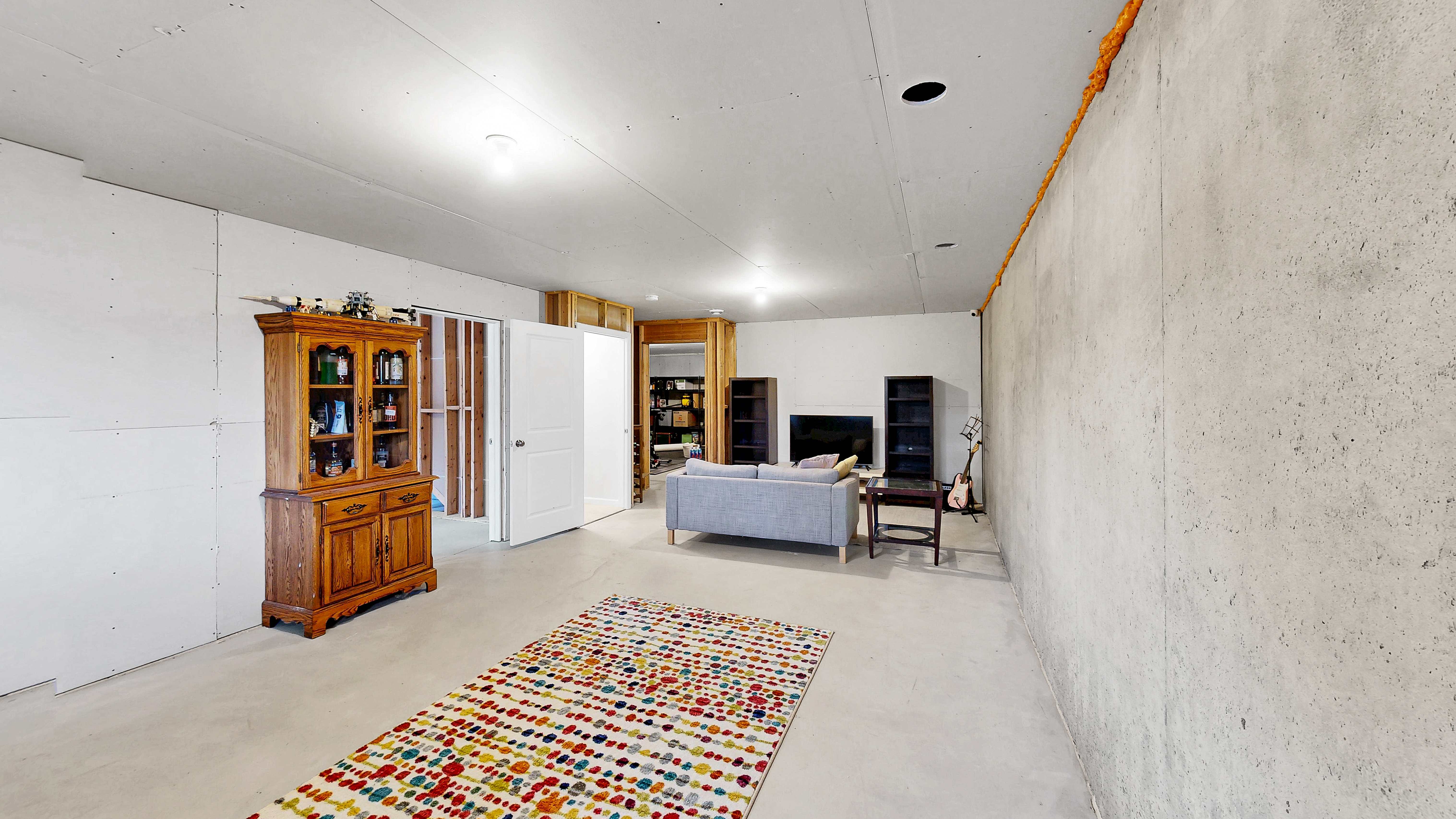 Unfinished lower level rec area with living space potential