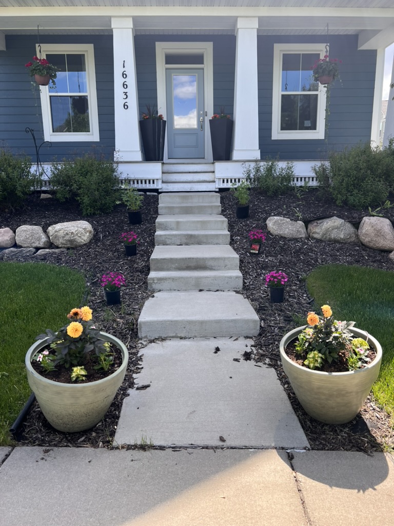 Covered front porch entrance with flower planters