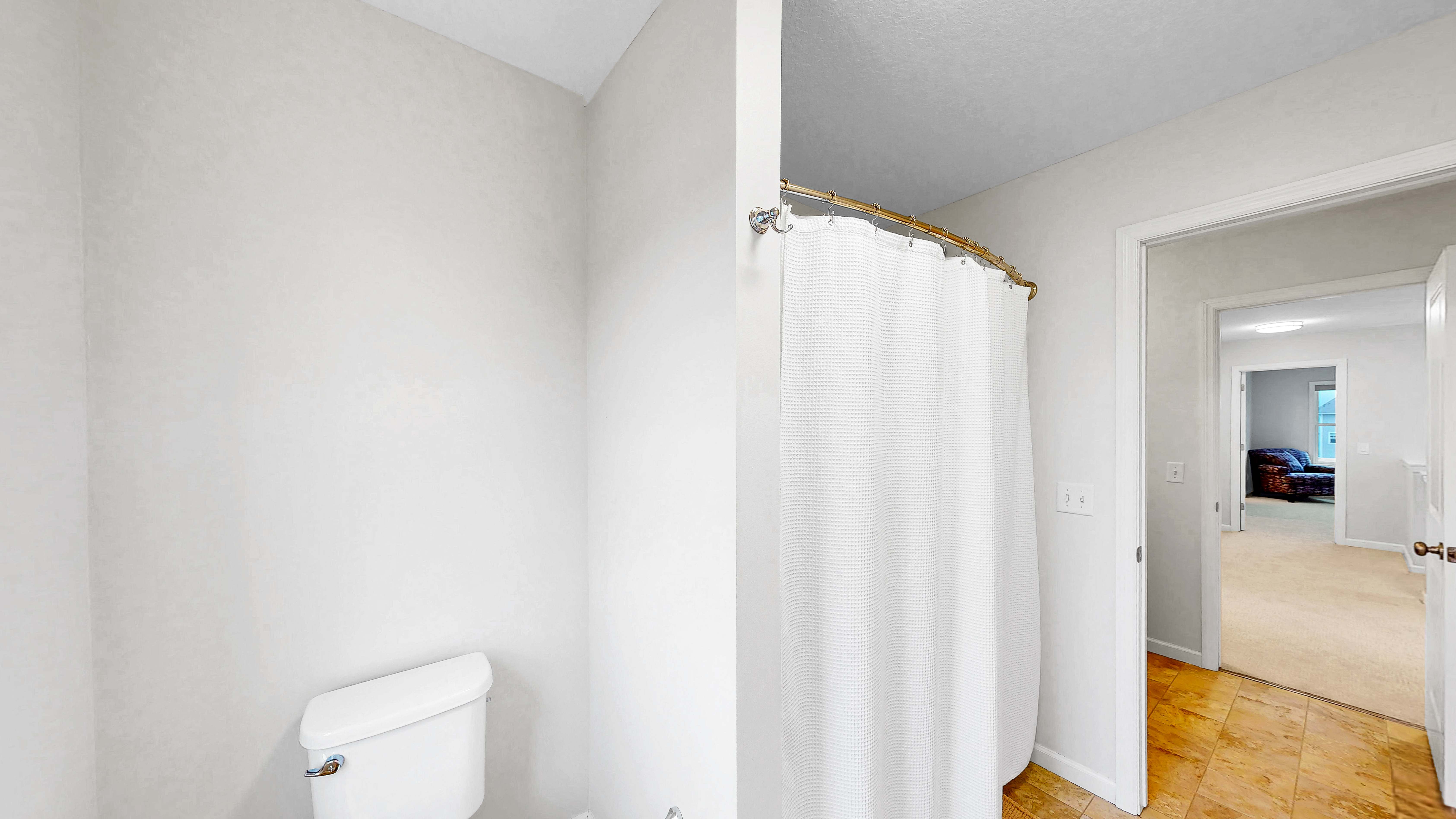 Upper level hall bath with shower curtain